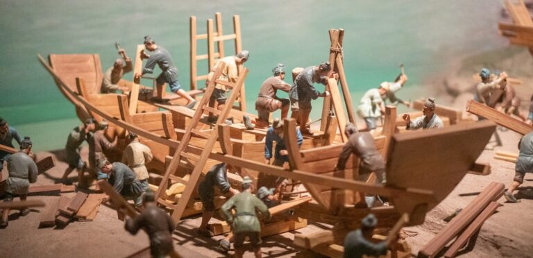 a group of toy figurines of men building a boat